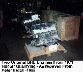(two engines sitting on shipping pallets with signs showing engine numbers)